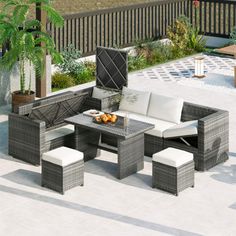 an outdoor patio furniture set with white cushions