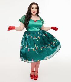 This charming plus size swing dress is crafted in a green satin-like fabric with a green skirt that dances with Christmas lights throughout and features dazzling lights that shine through the chiffon! Complete with a back zipper and elastic short sleeves..Available in sizes XS-5X while supplies last..Batteries not included | Unique Vintage Light Up Plus Size 1950S Green Christmas Lights Print Sweetheart Dress | Size 2X/18 Green Christmas Lights, Sweetheart Dress, Green Satin, Green Skirt, Green Christmas, Unique Dresses, Vintage Lighting, Fashion Help, Nordstrom Dresses