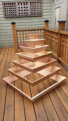 a stack of wooden shelves sitting on top of a wooden deck