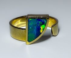 Mid century c1960s This is a fantastic MCM 14k piece with a fantastic Australian black Opal inlay in a unique abstract design. Good sized ring, solid and well made.  The video is so so because, I am waiting for the sun to come out and then I can demonstrate how gorgeous this Opal is. 4.3g 14k solid yellow gold Hallmarked Australian black Opal (possibly solid or an inlay) Face measures 11mm wide The band measure 4.8mm S 7.25 US resizable or adjustable Excellent vintage condition Modern 14k Gold Opal Ring With Polished Finish, Modern Opal Ring In 14k Gold With Polished Finish, Modern 14k Gold Opal Ring For Formal Events, Modern 14k Gold Opal Ring For Formal Occasions, Collectible Modern 14k Gold Jewelry, Modern 14k Gold Collectible Jewelry, Unique Yellow Gold Opal Ring With Polished Finish, Modern Yellow Gold Collectible Rings, Unique Formal Opal Ring In 14k Gold