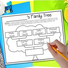 a child's hand holding a pencil over a family tree chart on a table