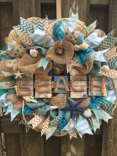 a wreath made out of burlocks and ribbons with the word beach on it