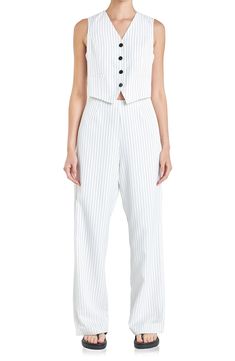 Fall for the sophisticated silhouette of this jumpsuit designed with polished pinstripes and a vest bodice. Front button closure V-neck Sleeveless Back welt pockets Lined 96% polyester, 4% spandex Hand wash, dry flat Imported Tailored Sleeveless Spring Pantsuit, Tailored Sleeveless Pantsuit For Summer, Tailored Sleeveless Summer Pantsuit, Spring Workwear Vest With Vertical Stripes, Sleeveless Pantsuit With Pockets For Spring, Sleeveless Spring Pantsuit With Pockets, Elegant Striped Vest For Spring, Tailored Pinstripe Vest For Spring, Elegant Pinstripe Sleeveless Vest