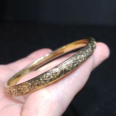 *Description: This is a great Whiting & Davis embossed gold tone floral bangle bracelet from the late 1960s to 1970s. The bracelet is in great condition and is signed on the inside of the bangle. This would be a great vintage bangle bracelet for your collection of Whiting & Davis and would also make a great gift. It would be the perfect bracelet to layer with other bangles. It is an over the hand bracelet, no clasp. *Approximate Measurements: Length - 7 1/2 Inches, Width - 1/4 Inch *Cond Amp Davis, Bangle Bracelet Gold, Formal Earrings, Vintage Bangle Bracelets, Vintage Christmas Gifts, Book Pieces, Late 1960s, Vintage Bangles, Hand Bracelet