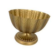 a large brass bowl sitting on top of a table