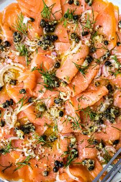 a platter filled with salmon and olives