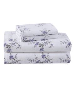 the sheet set is white with purple flowers on it and has two sheets folded over them