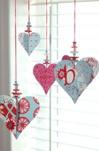 valentine's day decorations are hanging from the ceiling and in front of a window