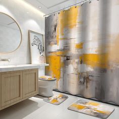 a bathroom with yellow and gray shower curtain, rugs and toilet paper on the floor