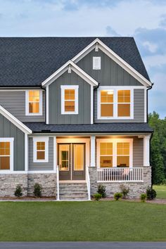 There is nothing like a cozy, covered front porch to welcome you home after a long day and the Kendall's porch does just that! Framed by white pillars complemented by stone steps this space is perfect for relaxing evenings or enjoying a cup of coffee in the morning. Explore the Kendall at Weatherford Estates in Angier, North Carolina. White Pillars, Vertical Siding, Stone Steps, Exterior Stone