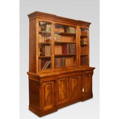 an old wooden bookcase with many books on the top and bottom shelves in it