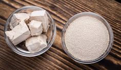 two bowls filled with sugar and marshmallows on top of a wooden table