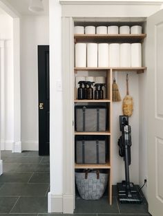 the shelves in this bathroom are filled with cleaning supplies