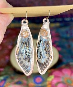 These genuine, ethically-sourced, cicada wings have been sealed in resin, then electroformed with a thick plate of copper. A sunstone cabochon adorns each earring, which hangs from a brass earwire. Nature-inspired Electroformed Brass Earrings, Bronze Copper Spiritual Earrings, Spiritual Bronze Copper Earrings, Brown Electroformed Brass Earrings, Adjustable Electroformed Bronze Earrings, Cicada Wings, Insect Wings, Boho Pendant, Yellow Earrings