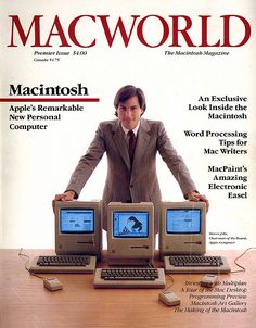 a man standing behind two computers on top of a table with the cover of macworld magazine