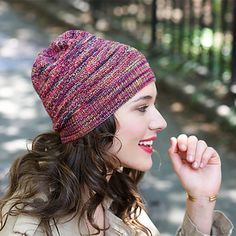 a woman wearing a knitted hat while talking on her cell phone