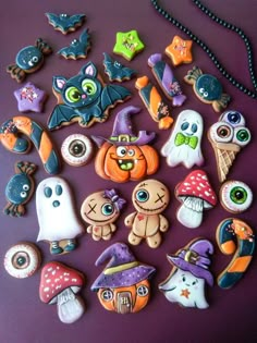 halloween cookies are arranged on a purple surface