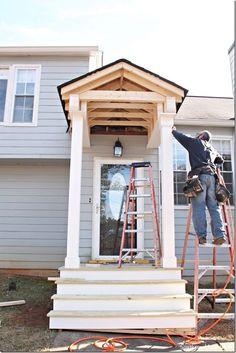 a man on a ladder painting the side of a house with white paint and wood