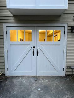 two white garage doors are open in front of a house