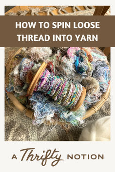 a basket filled with yarn and spools on top of a rug next to a knitting needle