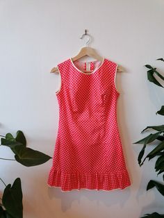 Celebrate the empowering spirit of the '60s with our Coral Polka Dot Mini Dress, a nod to mod fashion and female strength. This vibrant dress boasts a cheeky frilled hem, adding a touch of playfulness to your ensemble. Adorned with white spots, the coral backdrop creates a striking contrast, while white trims on the neckline, arms, and hem enhance the dress's retro charm.  Measurements: Chest: 45cm (pit to pit) Length: 80cm (neckline to hem) Waist: 71cm (28 inches) Elevate your wardrobe with thi Summer Mod Dress With Buttons, Fitted Mod Mini Dress With Retro Print, 1960 Mini Dress, Mod Mini Dress With Retro Print, Retro Print Mod Mini Dress, 60s Mini Dress, Mod Mini Dress, Vibrant Dress, Mod Fashion