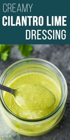 a glass jar filled with creamy glantro lime dressing on top of a table