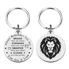 two key chains with lions on them and the words you are loved in different languages