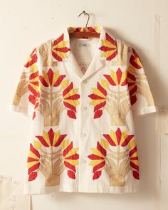 This short sleeve shirt is inspired by an unfinished quilt top from the 1900s. The shirt features a faithful reproduction of an unfinished appliqué quilt top of turkey red and yellow bunches of flowers.  Boxy, cropped fit  Four front buttons  100% cotton  Made in India   Dry clean only View all shirts All wear, mending Bunches Of Flowers, New York Shopping, Victorian Quilts, Lace Long Sleeve Shirt, Floral Long Sleeve Shirt, Quirky Fashion, Long Sleeve Plaid Shirt, Men Shirt Style, Red And Yellow