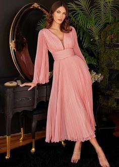 Transform any gathering into a blossoming affair with our enchanting maxi dress. Crafted from delicate chiffon, this dress boasts elegant pleats cascading from the sleeves to the hem. This dress gives an elegant take on the deep V-neckline and cinched waist combo. Embrace its multi-layered A-line silhouette, tailored to suit any occasion. Tea Length SIZE CHART Measurements are in inches Size Chest Waist Hips 4 34 26 37 6 35 27 38 8 36 28 39 10 37 29 40 12 38 30 41 14 40 32 43 16 42 34 45 18 44 3 Gowns Simple, Tea Length Prom Dress, Tea Length Skirt, Cinderella Divine, Chiffon Shorts, Prom Ball Gown, Pleated Chiffon, Party Dress Long Sleeve, Dresses Elegant