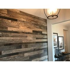 a room with wood paneling on the wall and a chandelier hanging from the ceiling