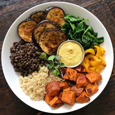 a white bowl filled with different types of food on top of a marble countertop