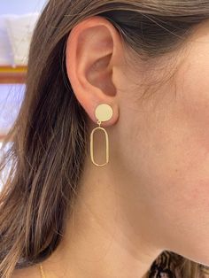 These Circle Paper Clip Dangle Earrings add a touch of class and modern style to your daily look. Made with 14 karat gold, the lightweight design and high polish make them perfect for everyday wear and to elevate your workplace attire. A must-have accessory for the fashion-forward individual! Details: Metal: Solid and Semi-Solid (Hollow) 14 karat gold Dimensions: Length: 1.5" Inch by 0.30" Wide, the circle is solid gold 10.0mm in diameter and the Oval Open Dangle (Hollow) 22.0mm (L) X 10.0mm (W) Modern Gold Plated Earrings For Formal Events, Modern Gold Plated Earrings For Formal Occasions, 14k Gold Oval Earrings For Everyday, Modern Shiny Finish Earrings For Gift, Minimalist Jewelry For Work, Minimalist Earrings With Shiny Finish For Everyday, Modern Gold Earrings With Shiny Finish, Minimalist Shiny Earrings For Everyday Wear, Minimalist Shiny Finish Earrings For Everyday