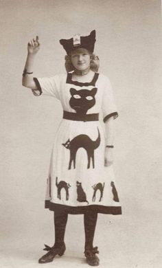 an old black and white photo of a woman dressed up as a cat with cats on it