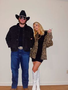 the man and woman are dressed up in cowboy hats, boots, and clothes for halloween