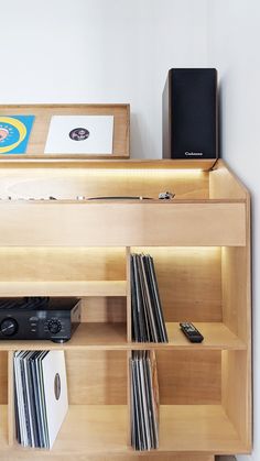 an entertainment center with records, cd's and speakers