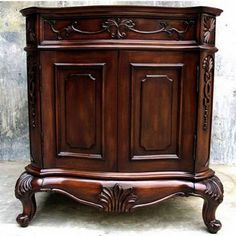 a wooden cabinet sitting on top of a cement floor