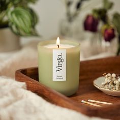 a candle sitting on top of a wooden tray