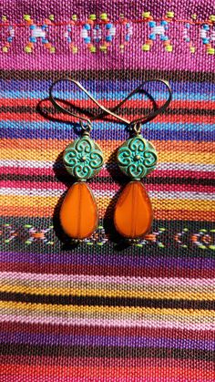 Bright orange earrings with Czech glass teardrops accented by gorgeous turquoise Patina metal beads.. Antique brass accent beads.  The one-of-a-kind earrings are 2 inches in length, including the antique brass ear wire hooks.  Lightweight. Unique. Handmade.  One of a kind design. Smoke free artist's studio. Orange Teardrop Jewelry With Matching Earrings, Handmade Orange Teardrop Earrings, Bohemian Orange Czech Glass Earrings, Bohemian Orange Teardrop Jewelry, Orange Bohemian Drop Earrings Jewelry, Orange Bohemian Drop Earrings, Turquoise Teardrop Czech Glass Earrings, Bohemian Orange Jewelry Nickel Free, Bohemian Orange Nickel-free Jewelry