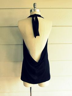 a mannequin wearing a black dress with a bow tie on it's neck