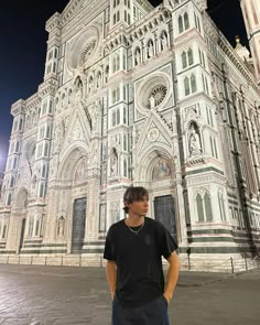 a man standing in front of a large building