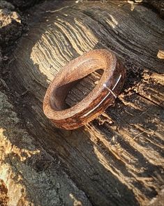 two wooden rings sitting on top of a piece of wood