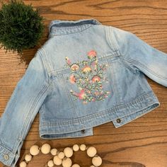 *Nwot* Baby Gap Jean Jacket With The Cutest Embroidered Flowers On The Back! Never Worn; Size 12-18m Blue Cotton Outerwear By Gap, Spring Cotton Outerwear For Playtime, Cute Fitted Embroidered Outerwear, Spring Blue Outerwear From Gap, Cute Outerwear For Spring Playtime, Spring Playtime Outerwear With Pockets, Cute Gap Cotton Outerwear, Cute Cotton Outerwear By Gap, Fitted Cotton Outerwear For Playtime