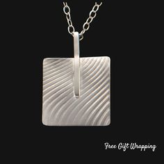 "Experience the striking allure of our Argentium Silver Square Bar Abstract Necklace. This piece is not just a necklace, it's a statement - a testament to the beauty of handcrafted art. Each square has a beautifully textured wave design and the bar that connects them are meticulously fashioned from high-quality Argentium silver, known for its bright white color, hypoallergenic properties, and resistance to tarnish. The abstract design exudes a modern aesthetic that plays wonderfully with light, Chic Wedding Style, Argentium Silver Jewelry, Silver Cuff Ring, Unique Sterling Silver Jewelry, Abstract Necklace, Handmade Silver Jewellery, Square Bar, Geometric Bracelet, Fluid Design