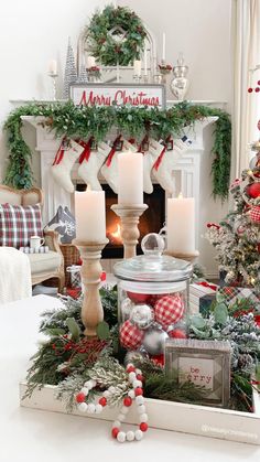 a christmas mantel with candles and ornaments