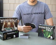 a man sitting at a table with some cards in front of him and two other items on the table