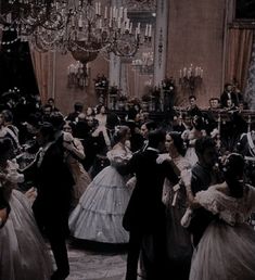 a group of people in formal dress dancing