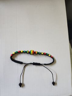 Jamaica Rasta Bead Bracelet,  for Men, Women, and Teens Cute addition to any outfit Casual Adjustable Wooden Beads, Adjustable Wooden Beaded Bracelet, Multicolor Beaded Casual Bracelets, Multicolor Casual Bracelet With Black Beads, Casual Multicolor Bracelets With Black Beads, Bead Bracelet For Men, Mens Beaded Bracelets, Bracelet For Men, Bead Bracelet