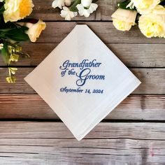 The handkerchief will read Grandfather of the Groom and the wedding date. The digitized example lettering is shown in medium grey.  The handkerchief is a traditional men's white handkerchief with a satin band and a hand rolled hem, measuring 16" by 16". The product is made in a smoke free home. Customizable White Handkerchiefs For Anniversary, Classic Wedding Handkerchiefs For Father's Day, Custom Text White Handkerchiefs For Wedding, White Custom Text Handkerchiefs For Wedding, White Handkerchiefs With Custom Text For Wedding, White Embroidered Text Handkerchief Wedding Gift, Embroidered Handkerchief Wedding