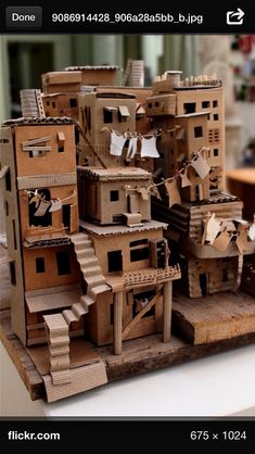 cardboard houses are stacked on top of each other