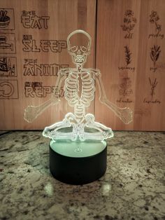 a glass skeleton sitting on top of a table